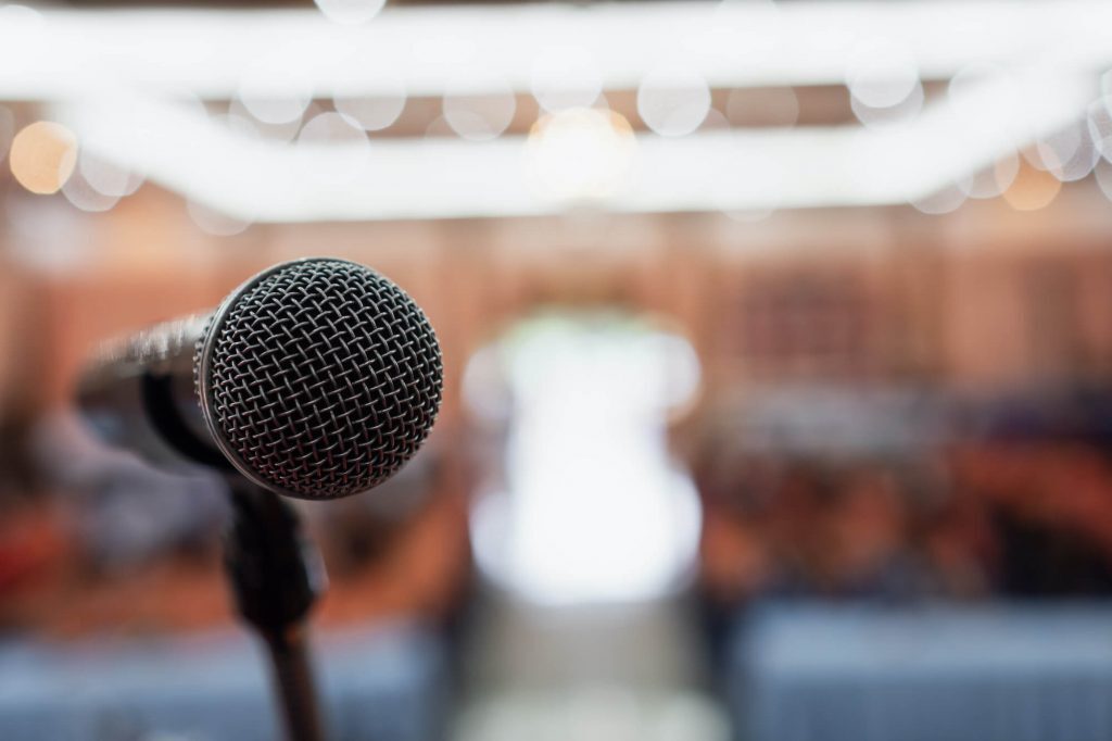Person standing at a microphone