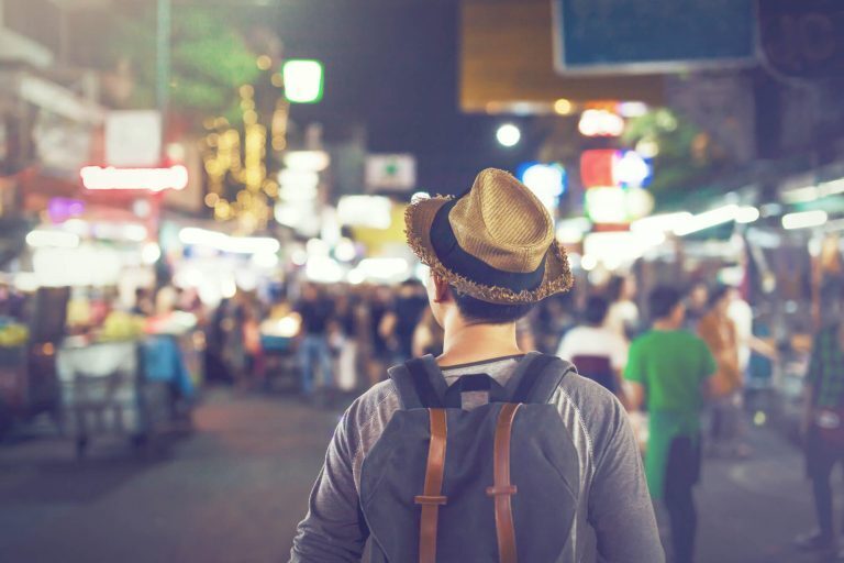 Man traveling through busy street