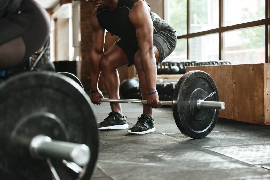 Cropped image of man weightlifting