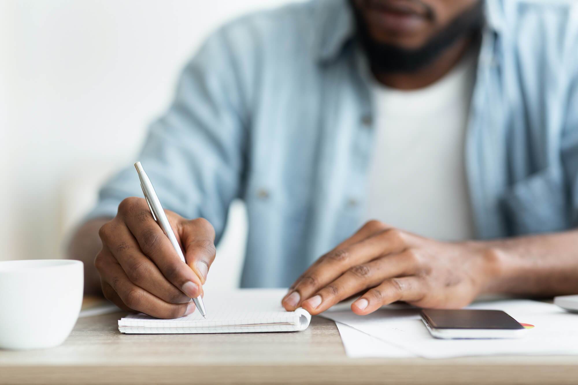 Man writing in notebook