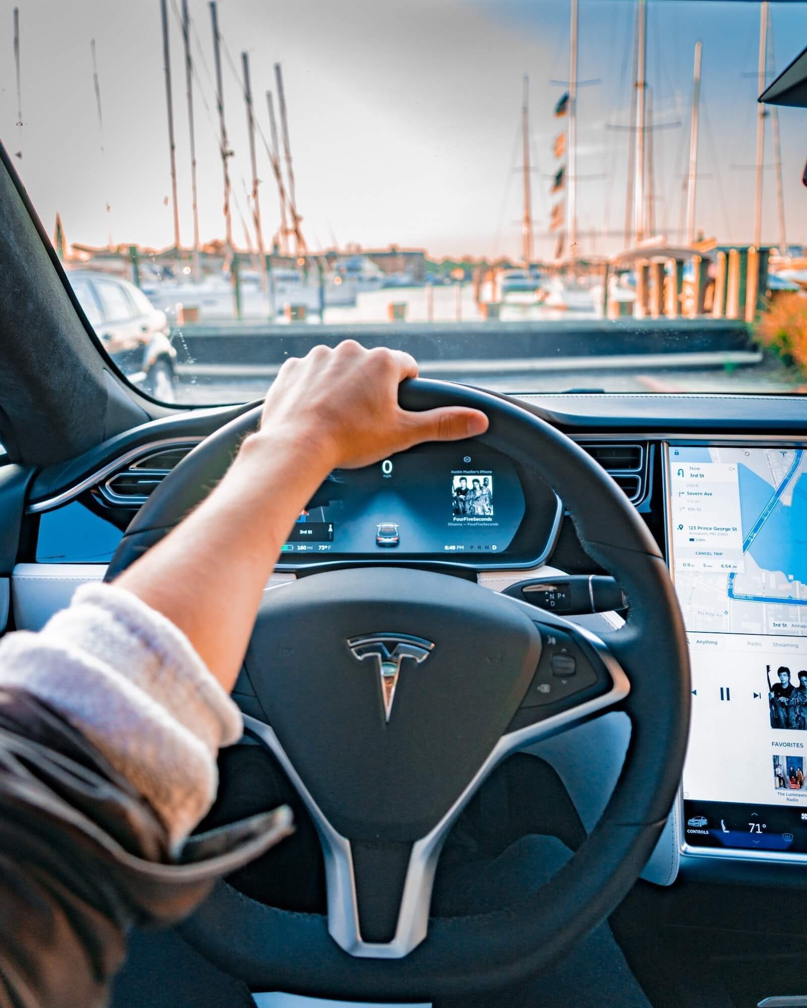 Man has his hands on Tesla steering wheel