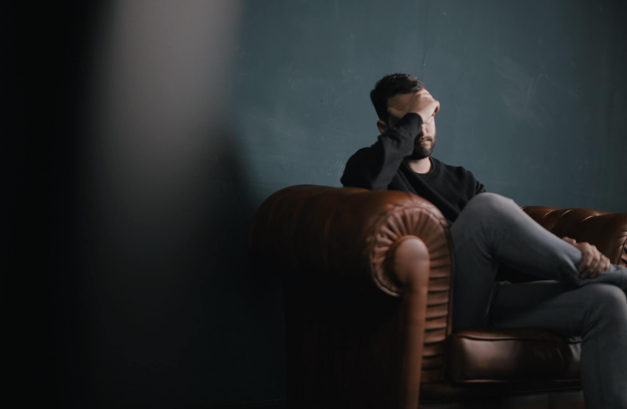 Sad man sitting on couch