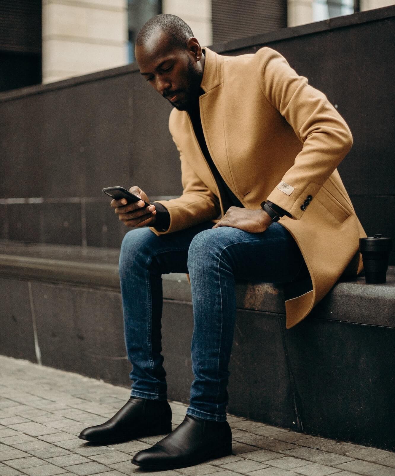 Man wearing overcoat and jeans