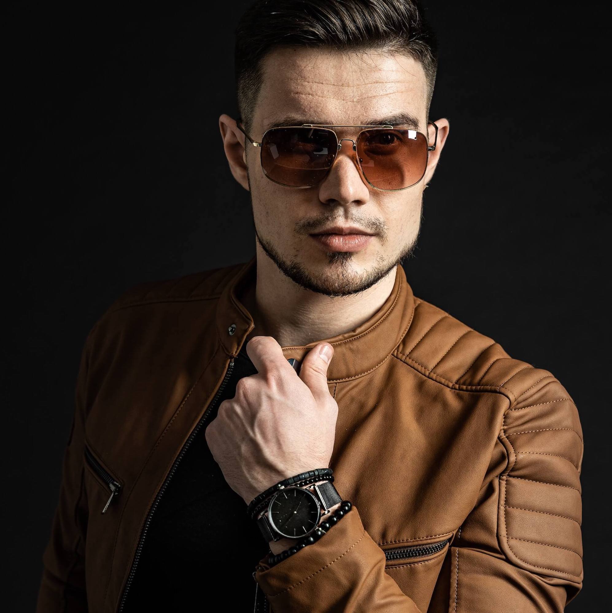 Man wearing watch and brown biker jacket