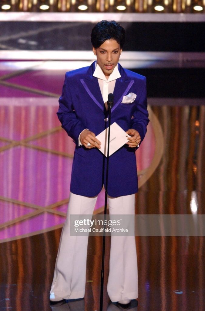 Prince in purple and white suit at Academy Awards