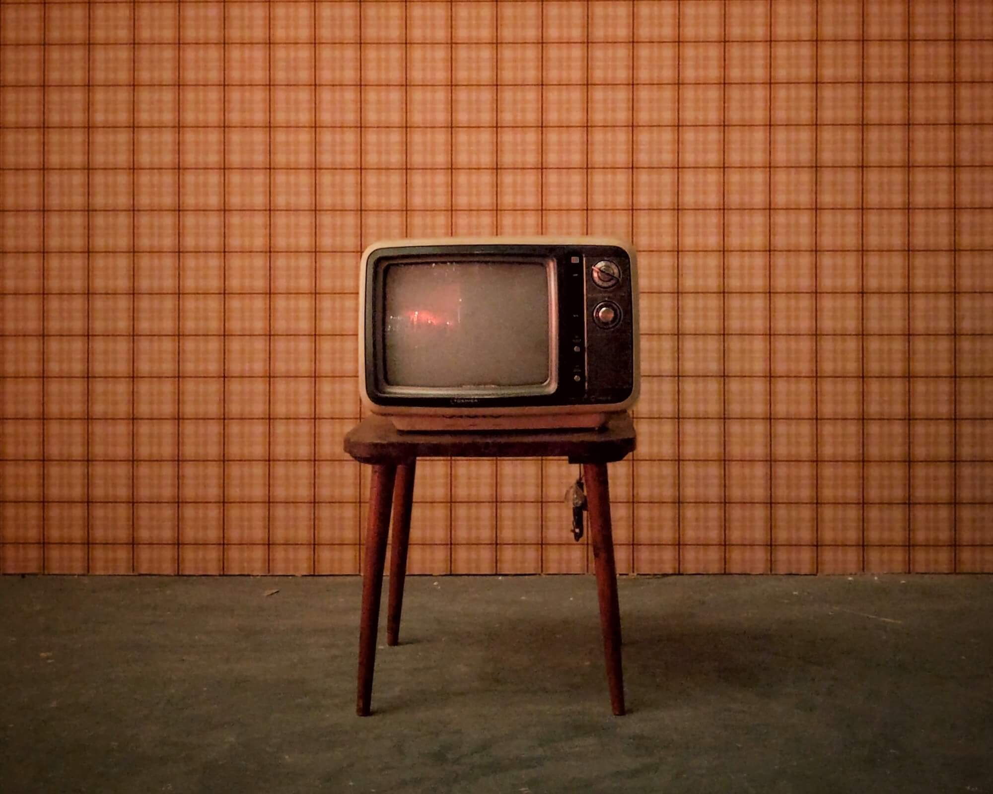 Retro television set on wooden stool