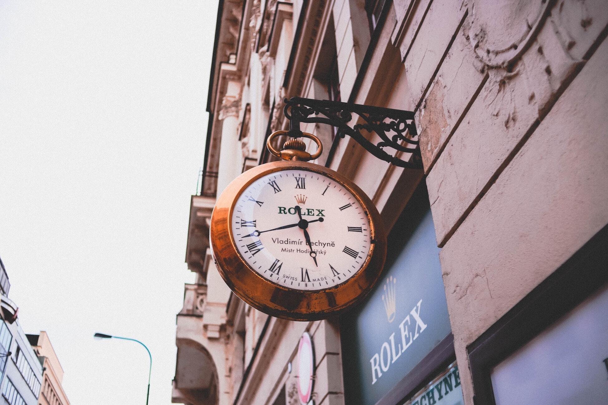 Rolex watch sign in front of a Rolex store