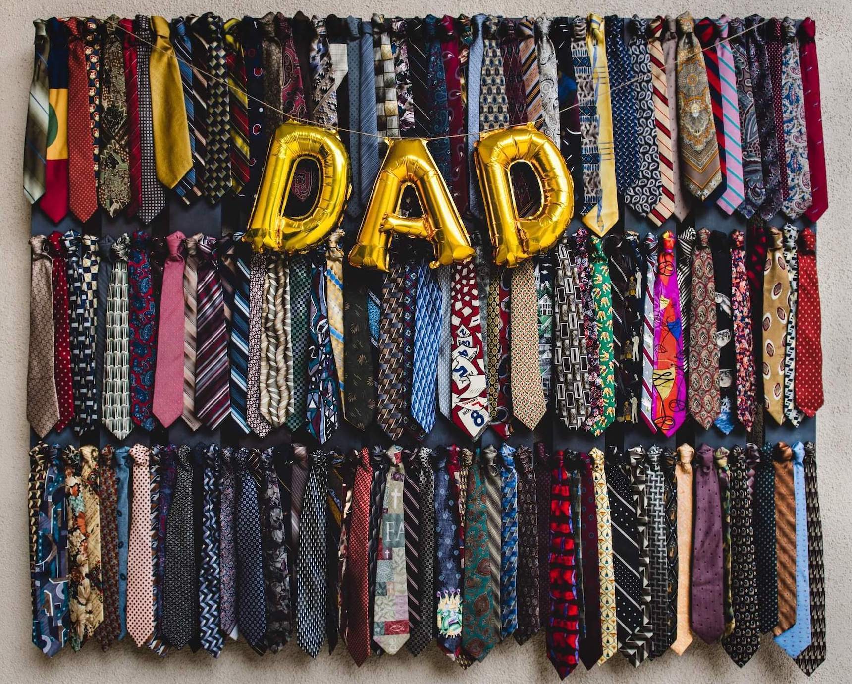 Dad in balloon letters on neck tie background