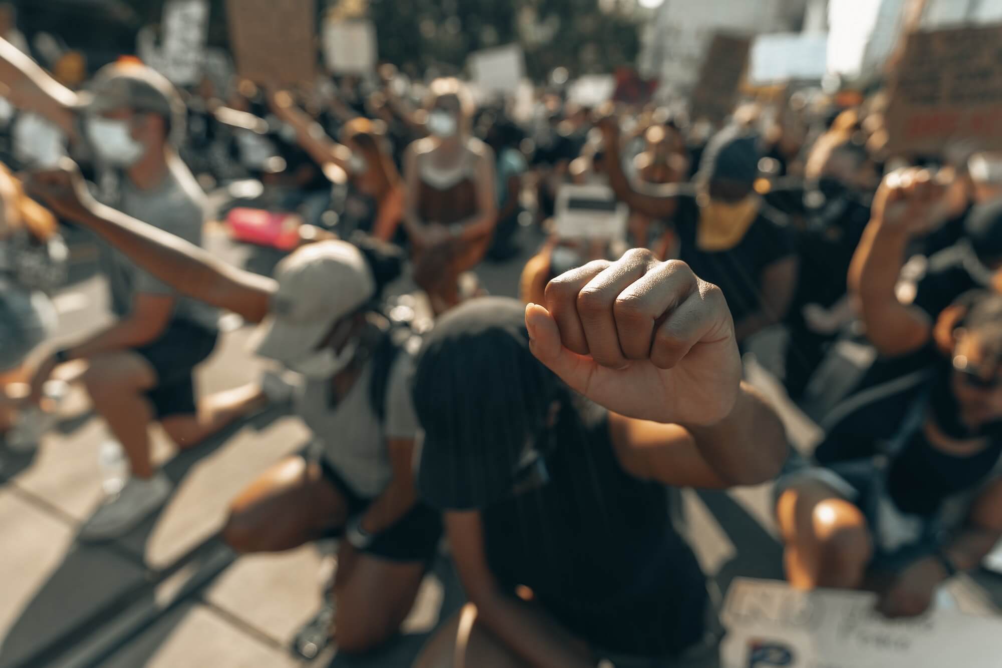 Protestors kneeling with raised fists