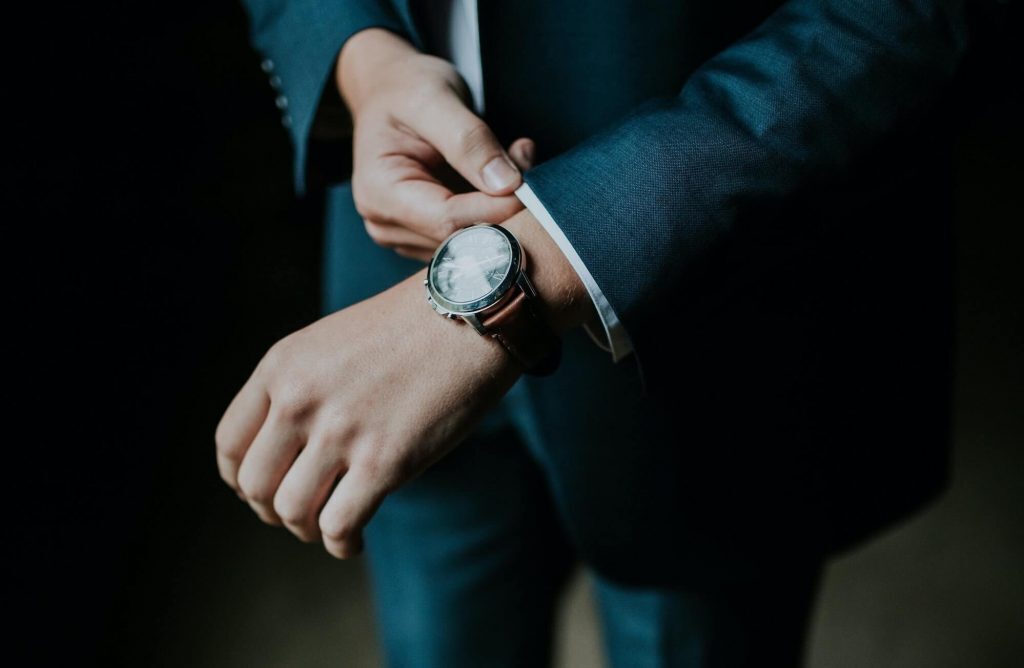 Man in suit wearing Fossil watch