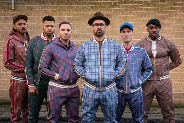 Colin Farrell and cast of The Gentlemen in different colored tracksuits