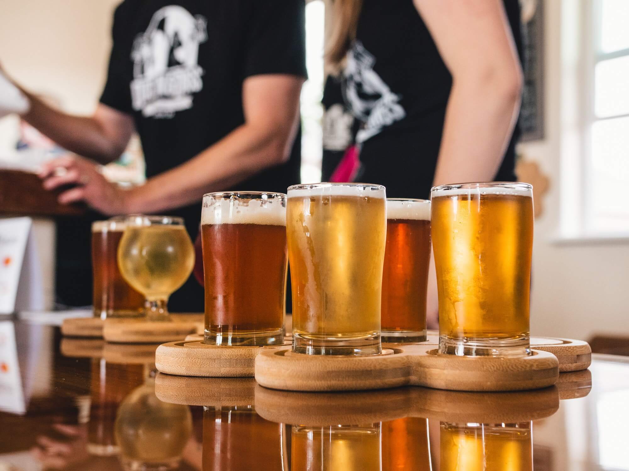 Selection of blond and red beer in pint glasses