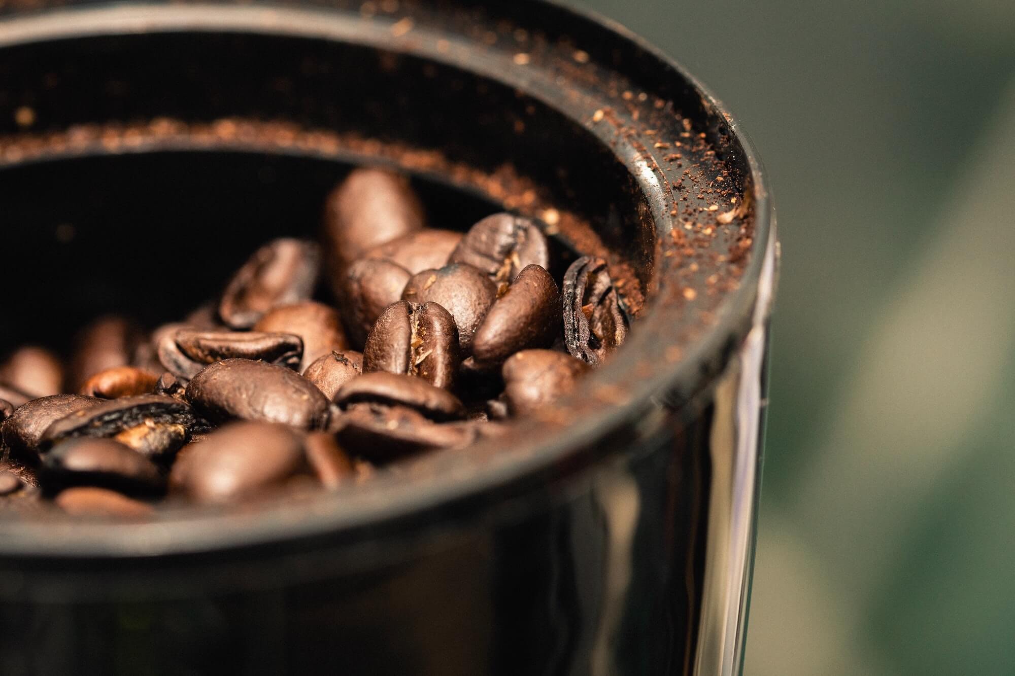 Close-up of coffee beans in a coffee grinder
