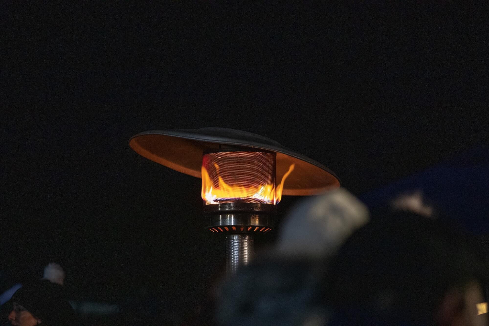 Outdoor patio heater aglow in the dark