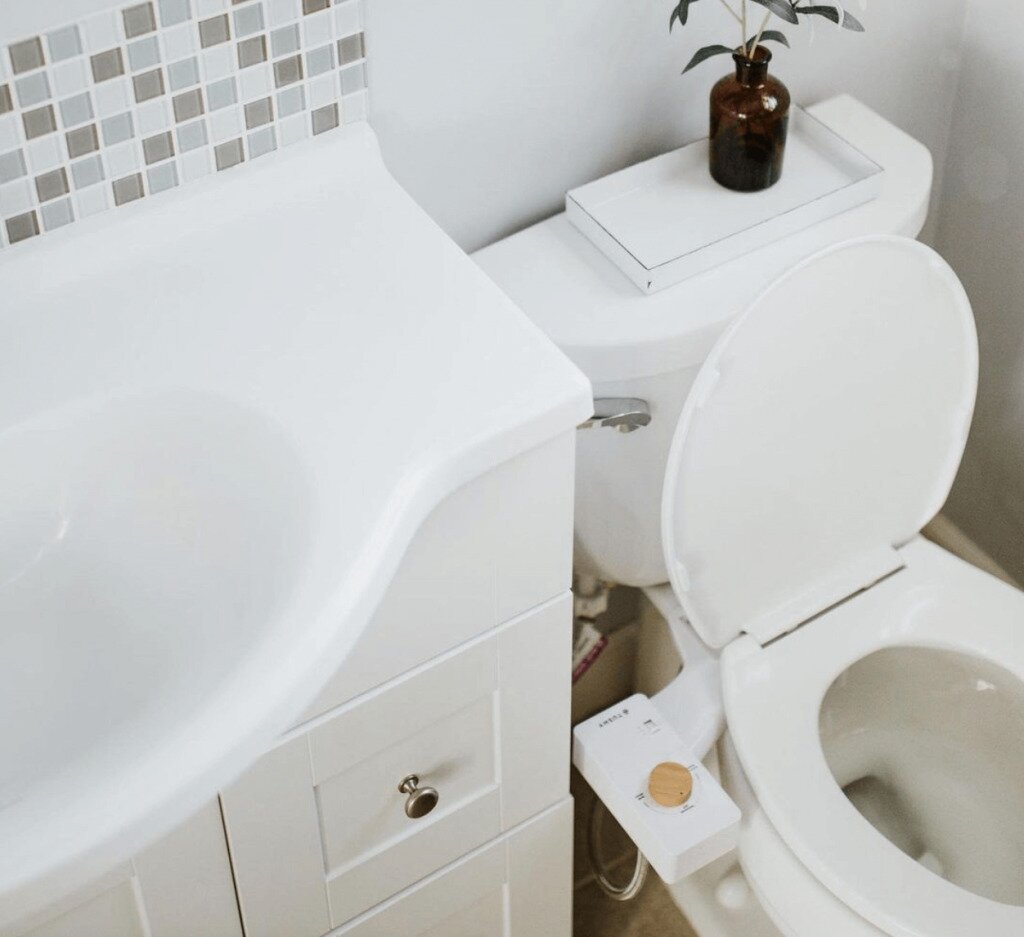 Modern bathroom with Tushy Spa 3.0 bidet attachment on toilet
