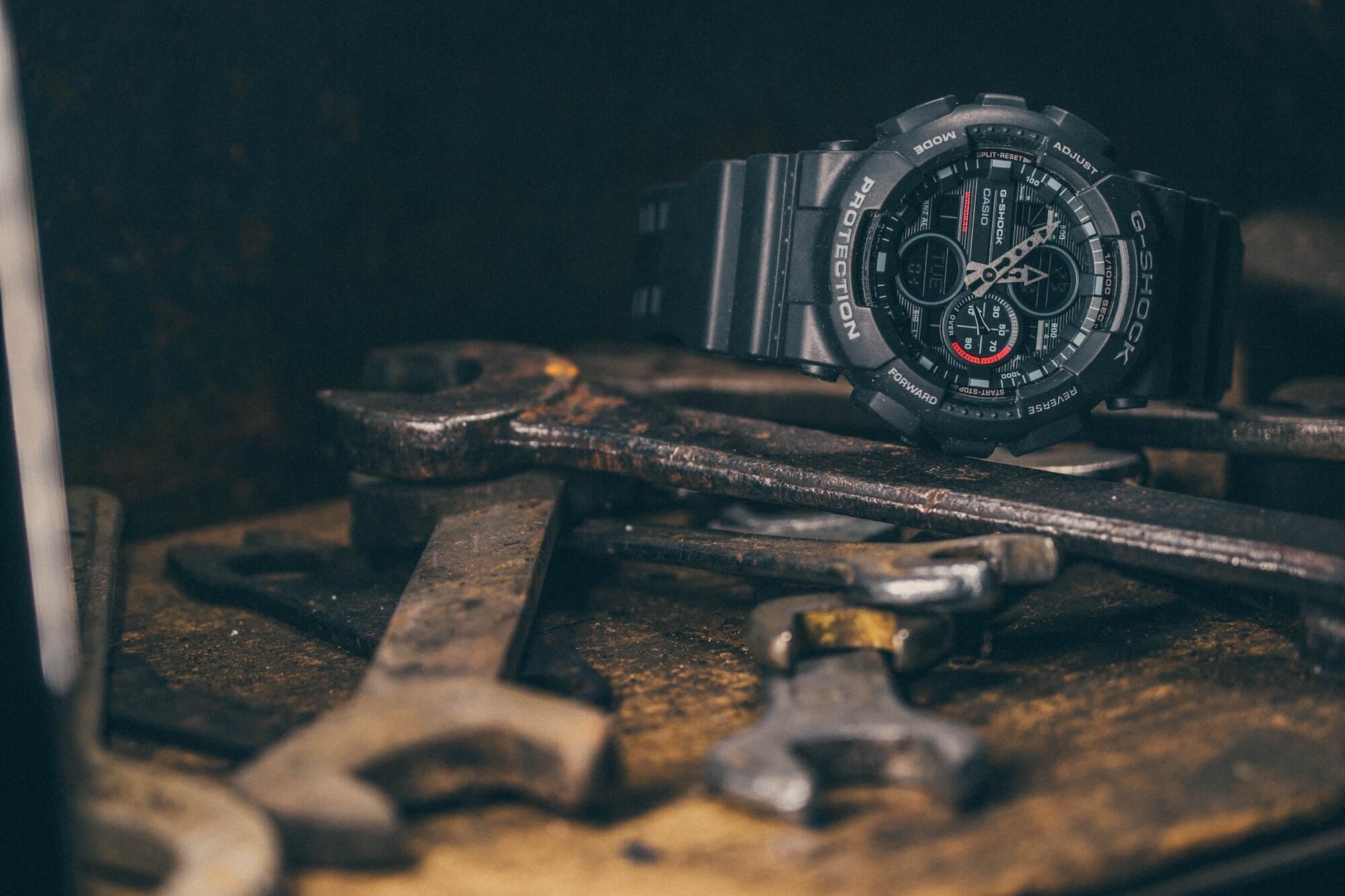 Durable Casio G-Shock displayed on a bed of metal tools