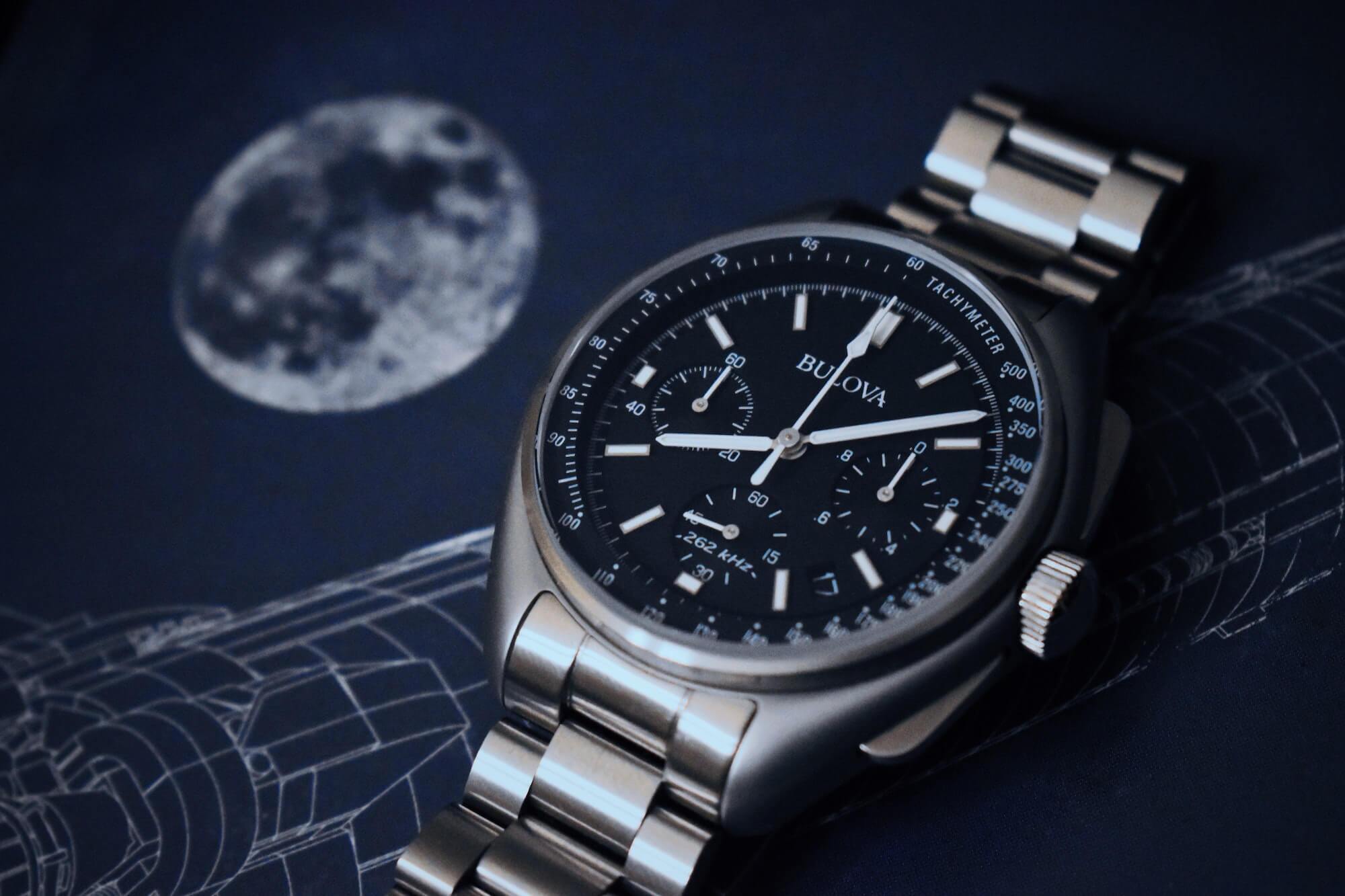 Close-up of Bulova Moon watch with moon picture in background