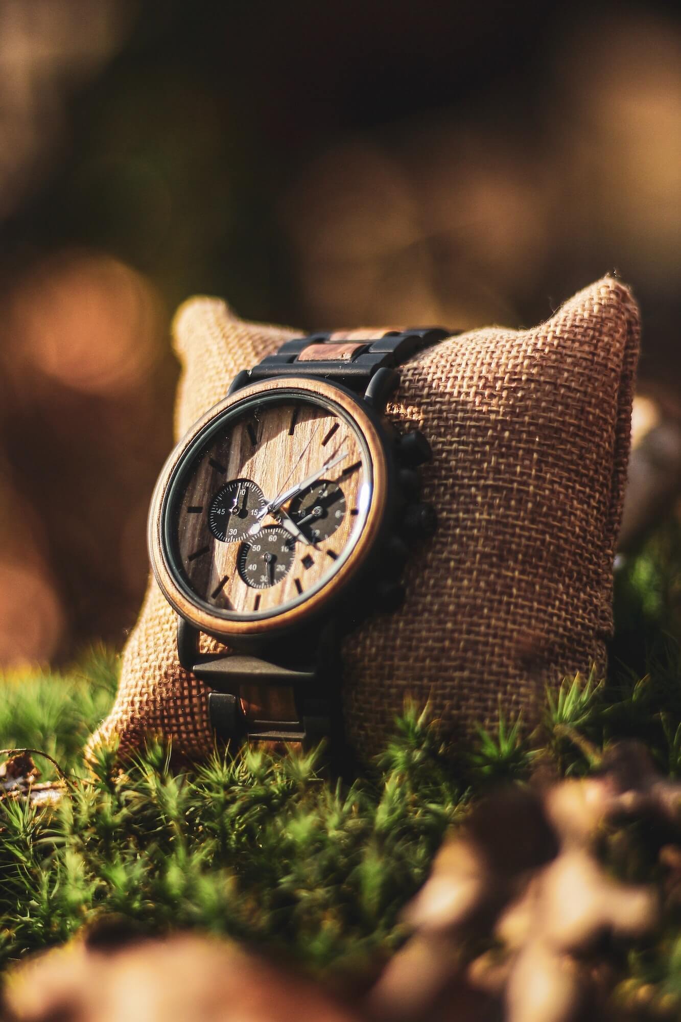 Wooden watch displayed on burlap pillow
