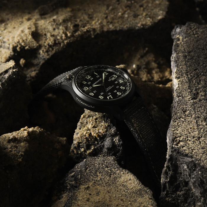 Hamilton titanium watch displayed against rocks
